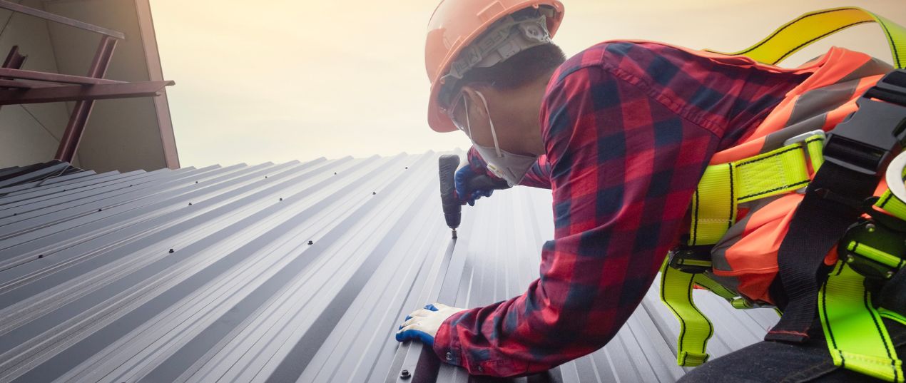 Worker Installing Commercial Roof Tiles