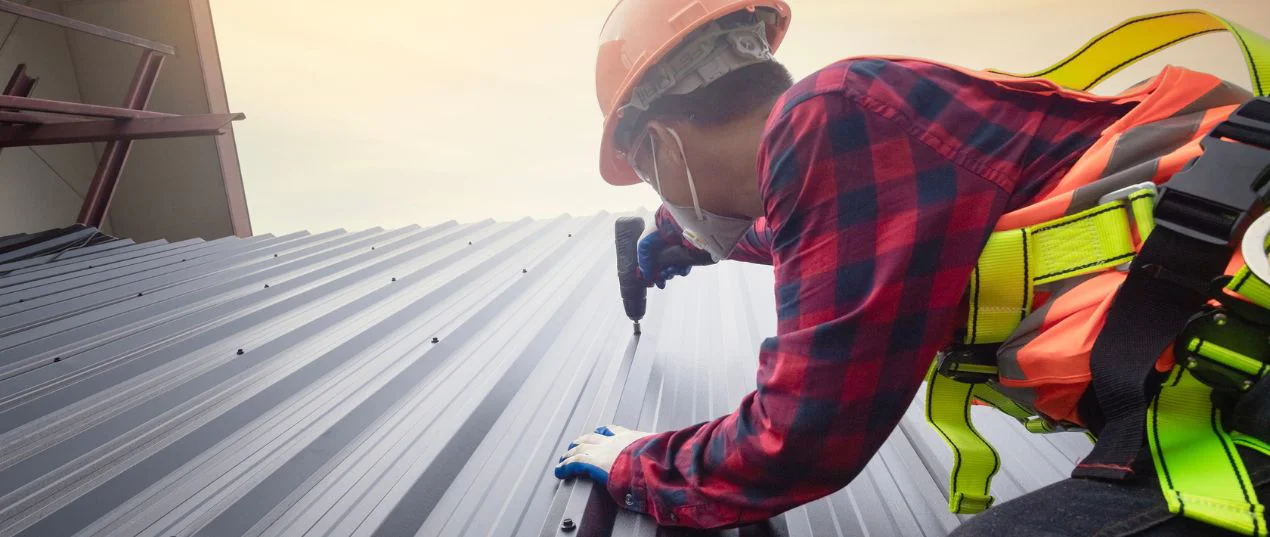 Worker Installing Commercial Roof Tiles